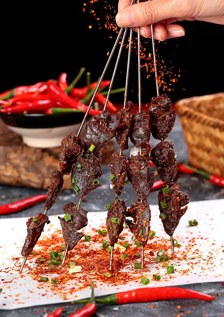 Spicy Beef Skewers Red Chili Flakes Green Onion Garnish