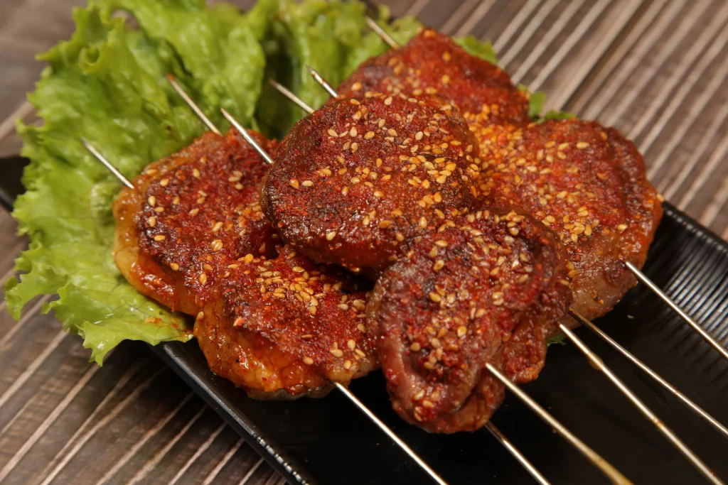 Spicy Beef Skewers Sesame Seeds Charred Crust Plated