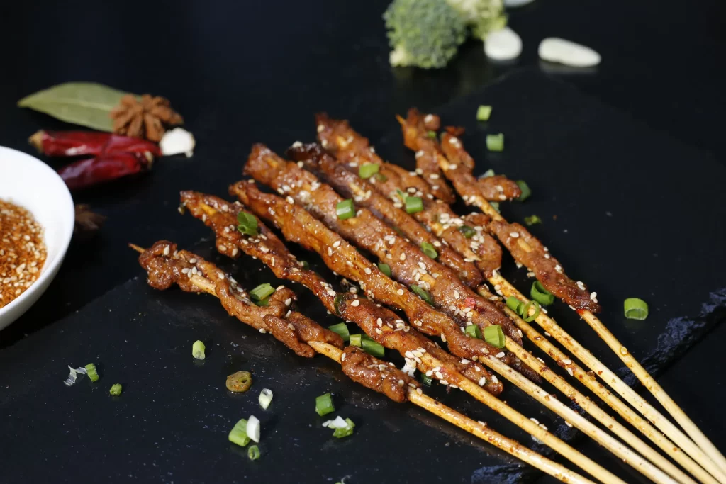Spicy Beef Skewers Sesame Seeds Green Onion Garnish