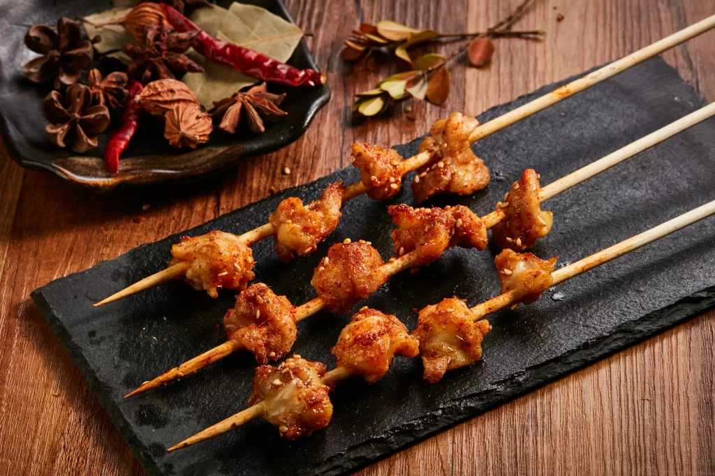 Spicy Chicken Skewers Sesame Garnish Black Slate Platter