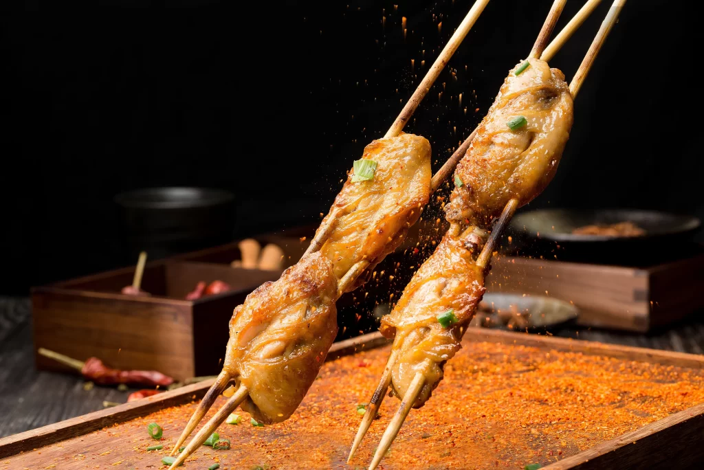 Spicy Chicken Skewers with Green Onion Garnish