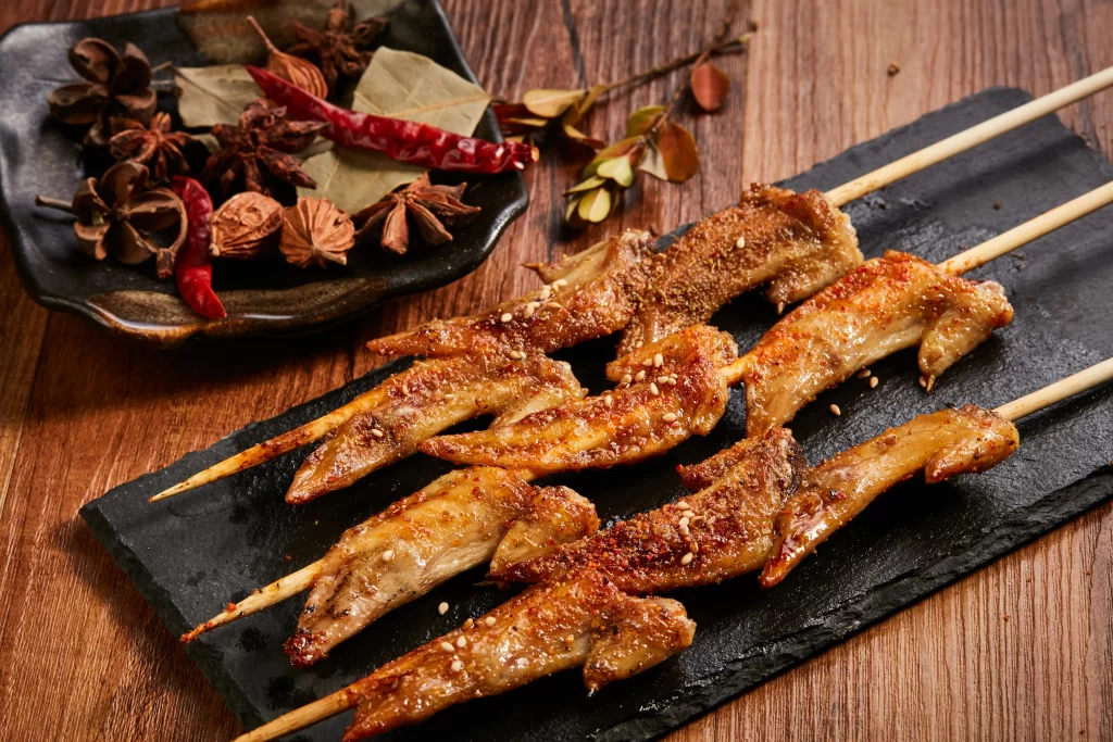 Spicy Chicken Skewers with Sesame and Chili Garnish