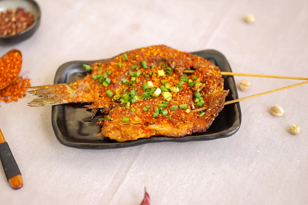 Spicy Grilled Fish with Green Onion Garnish