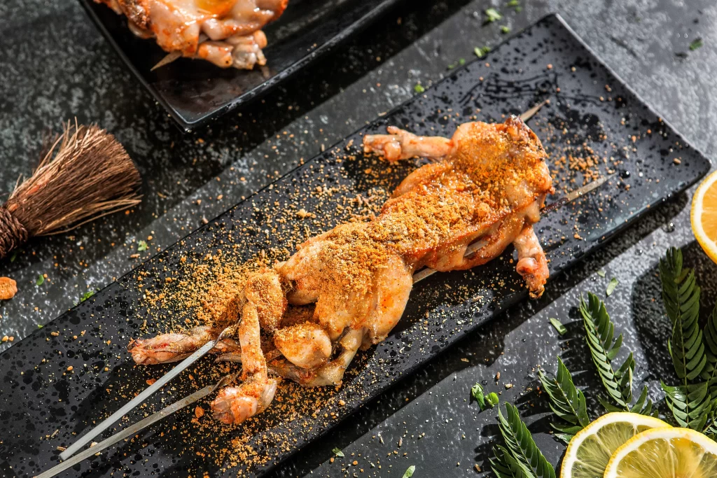 Spicy Grilled Frog Legs Golden Crust Black Plate