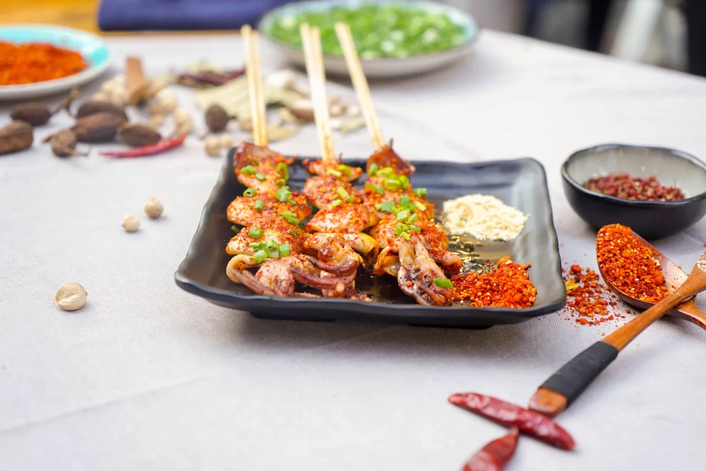 Spicy Grilled Octopus Skewers Red Chili Garnish Black Plate