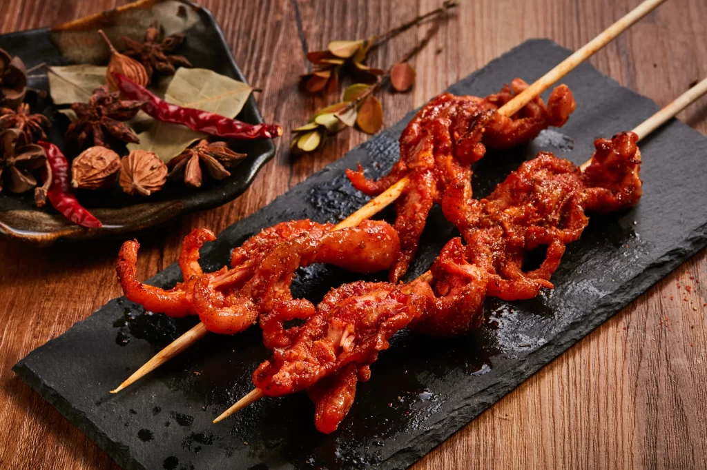 Spicy Grilled Octopus Skewers Red Sauce Charred Edges