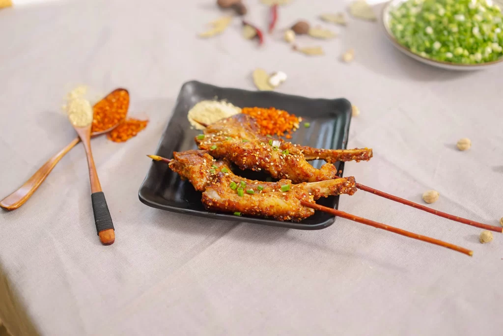 Spicy Grilled Pork Skewers with Sesame and Green Onion Garnish