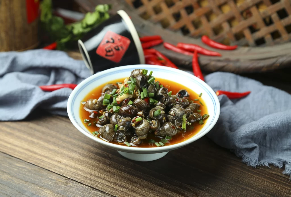 Spicy Grilled Snails Chili Sauce Green Onions White Bowl