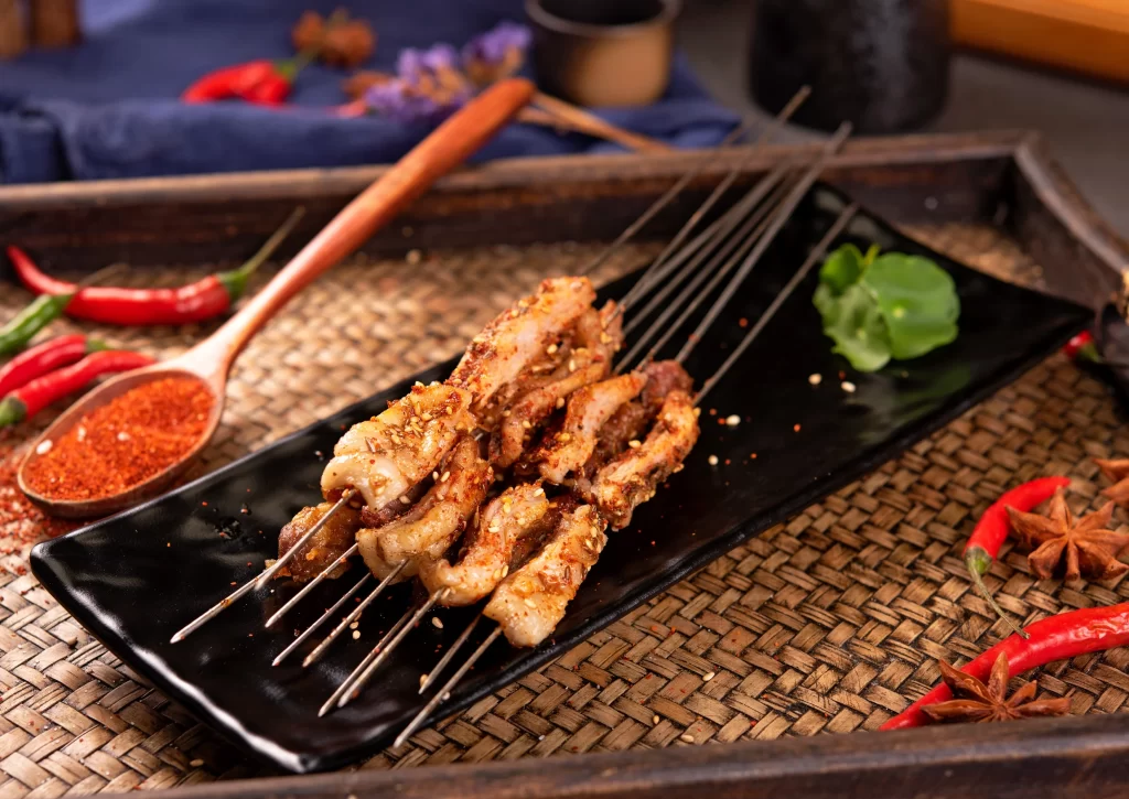 Spicy Pork Skewers Charred Crust Black Plate Garnish