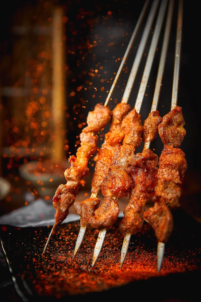 Spicy Pork Skewers Charred Crust Red Pepper Flakes Close Up