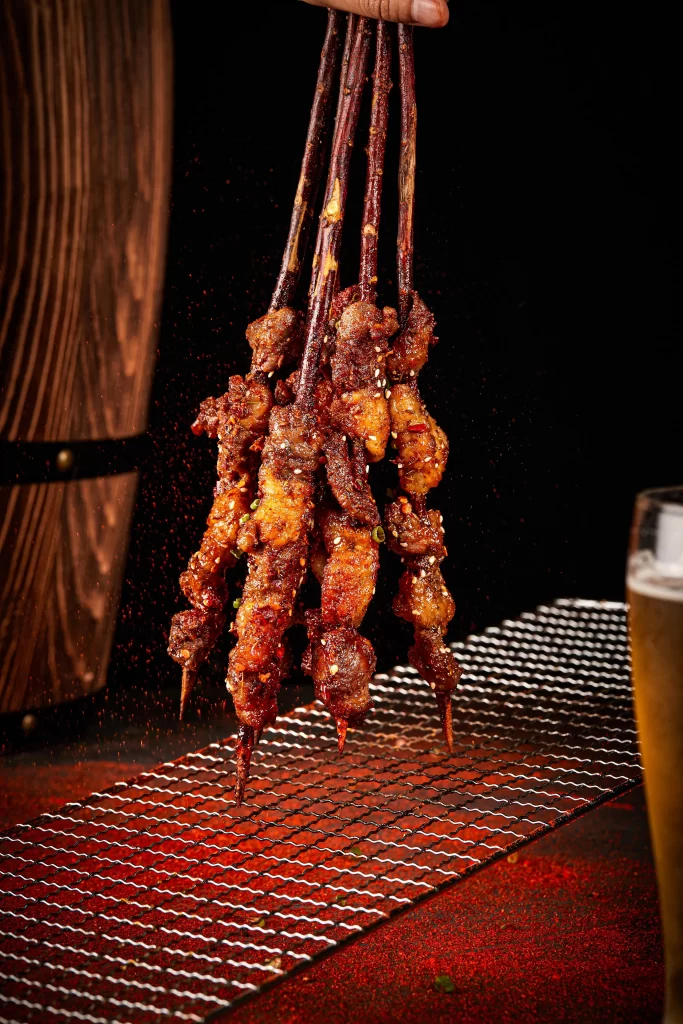Spicy Pork Skewers Charred Crust Red Pepper Garnish