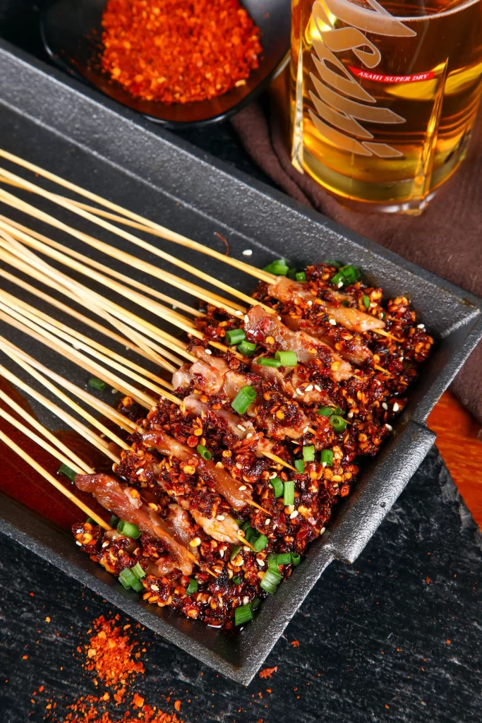 Spicy Pork Skewers Chili Flakes Green Onion Garnish