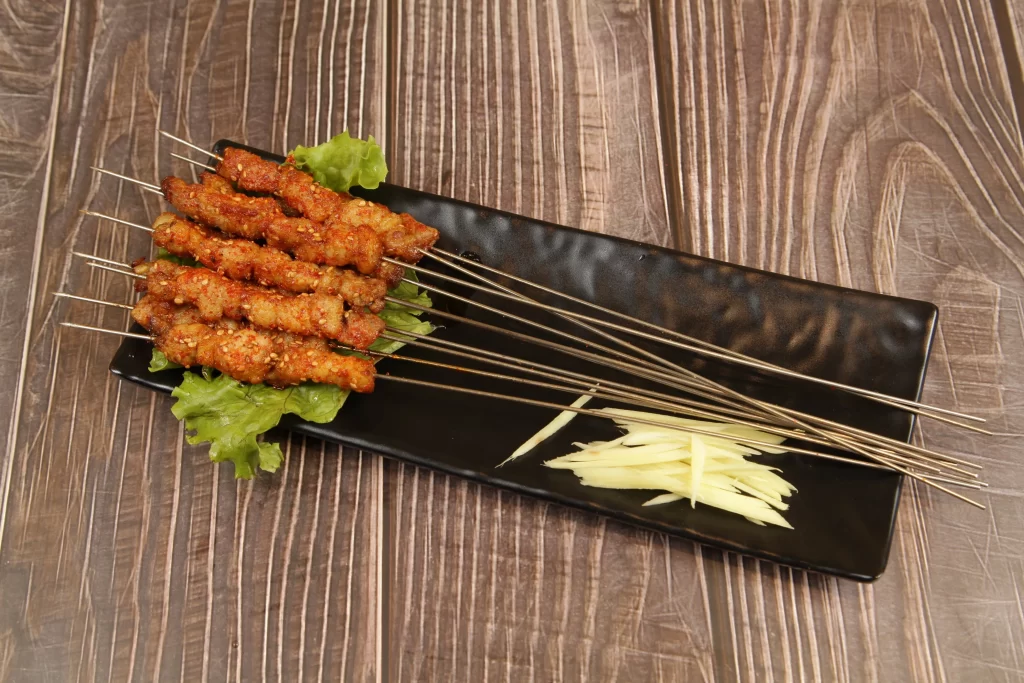 Spicy Pork Skewers Crispy Charred Garnished Lettuce