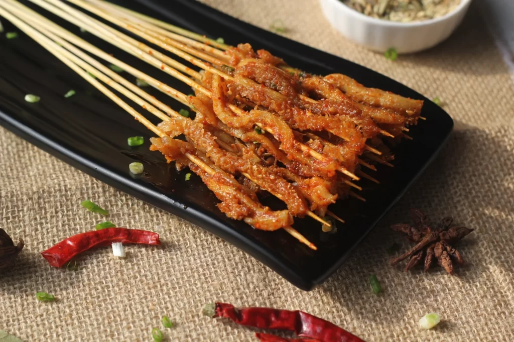 Spicy Pork Skewers Golden Brown Crispy Texture Black Plate