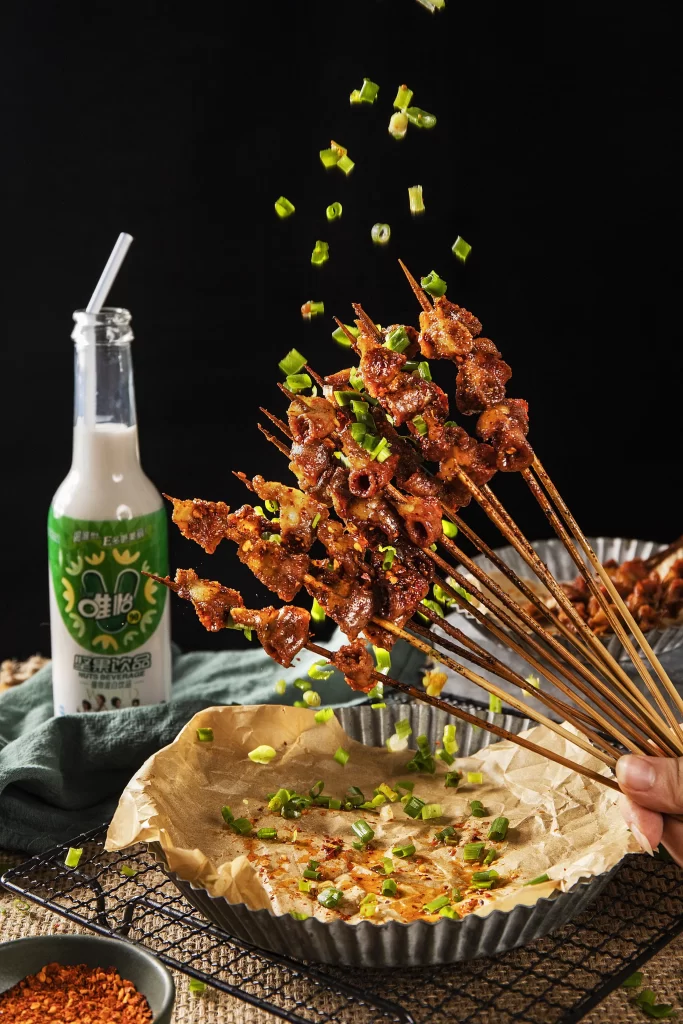 Spicy Pork Skewers Green Onion Garnish Charred Crust