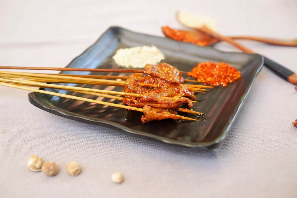 Spicy Pork Skewers Red Chili Crust Black Plate