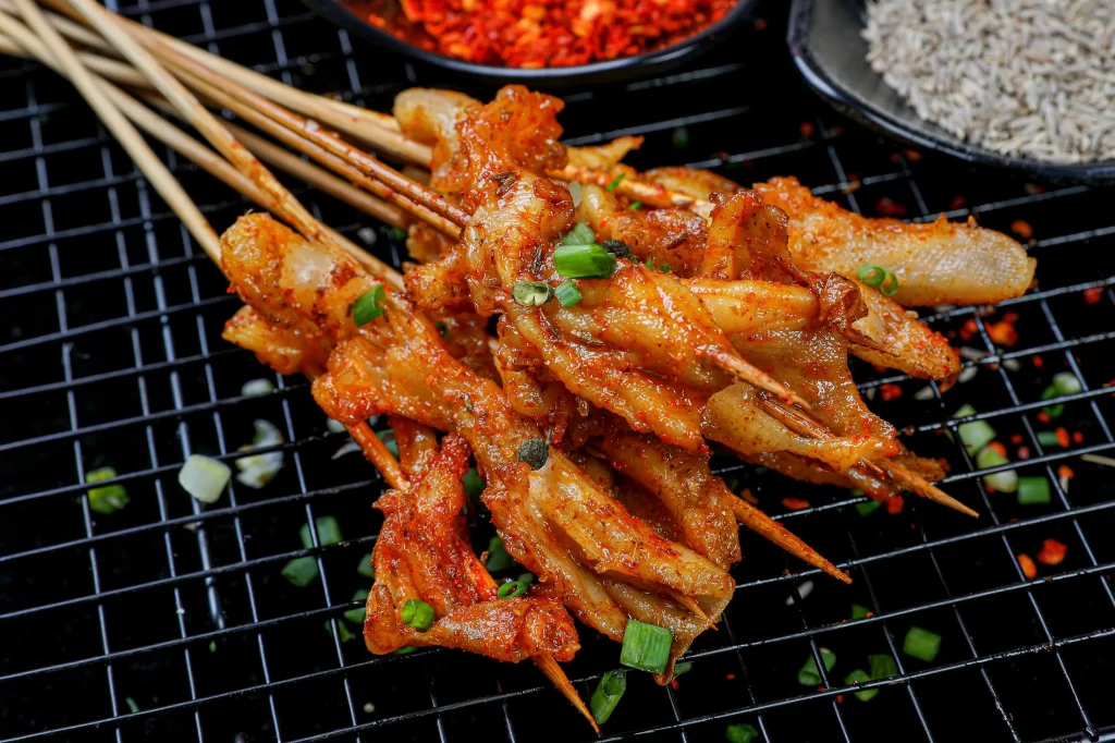 Spicy Pork Skewers Red Chili Sauce Green Onion Garnish