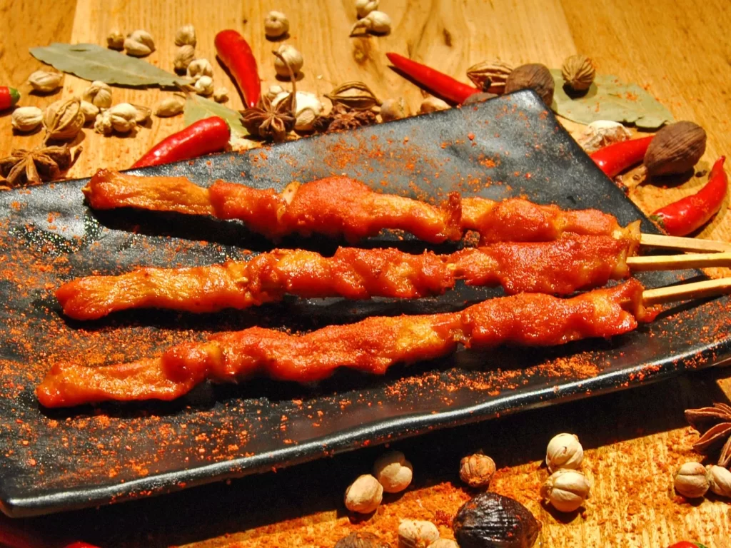 Spicy Pork Skewers Red Sauce Black Plate Garnish
