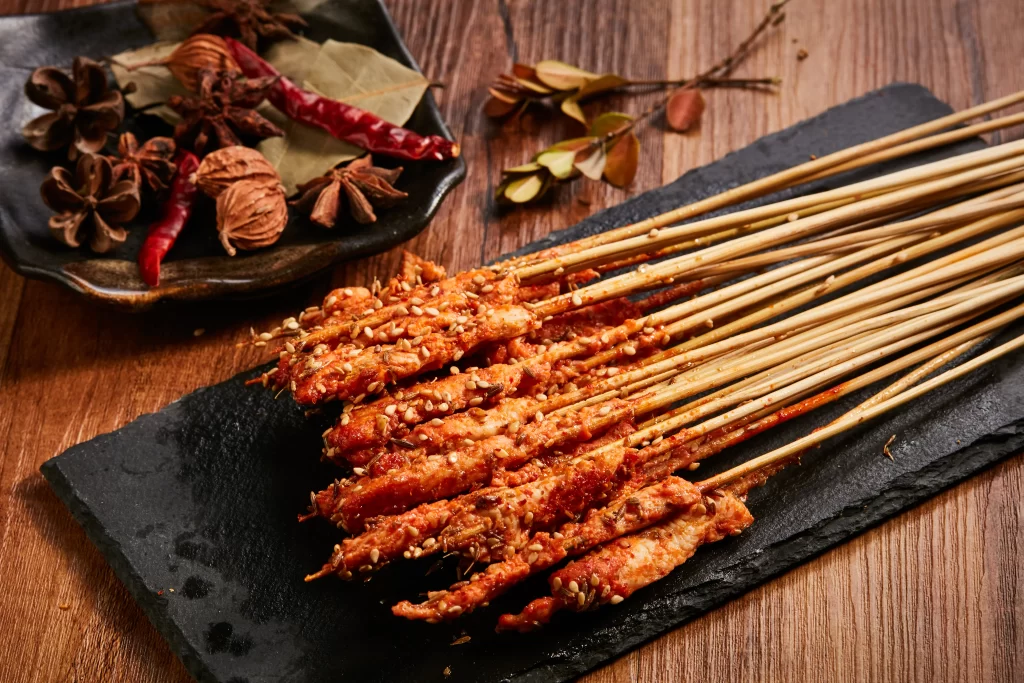 Spicy Pork Skewers Sesame Seeds Red Sauce Black Slate