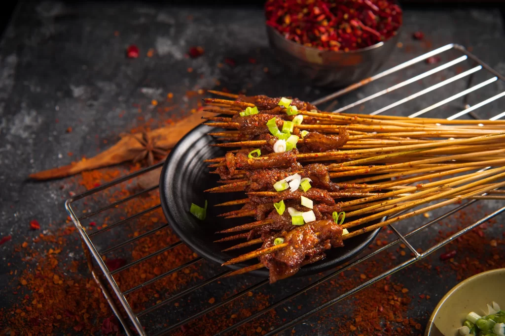 Spicy Pork Skewers with Green Onion Garnish