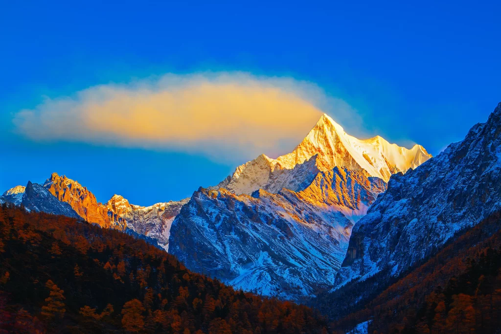 sunset golden amber orange snow peak ridge valley clouds cyan