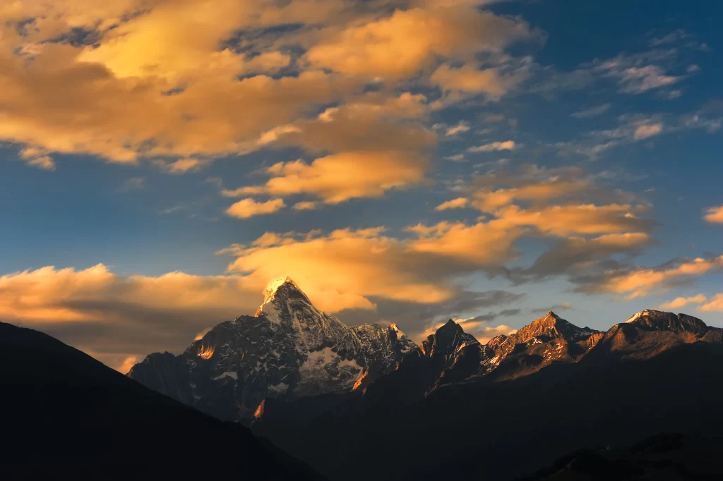 sunset golden amber orange snow peak ridge clouds