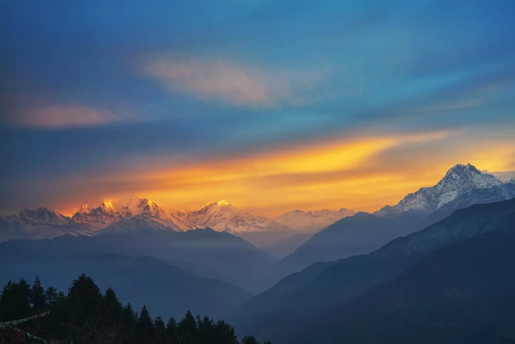 sunset golden amber orange snow peak ridge valley clouds blue