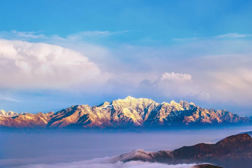 sunset golden amber snow peak ridge clouds panoramic orange