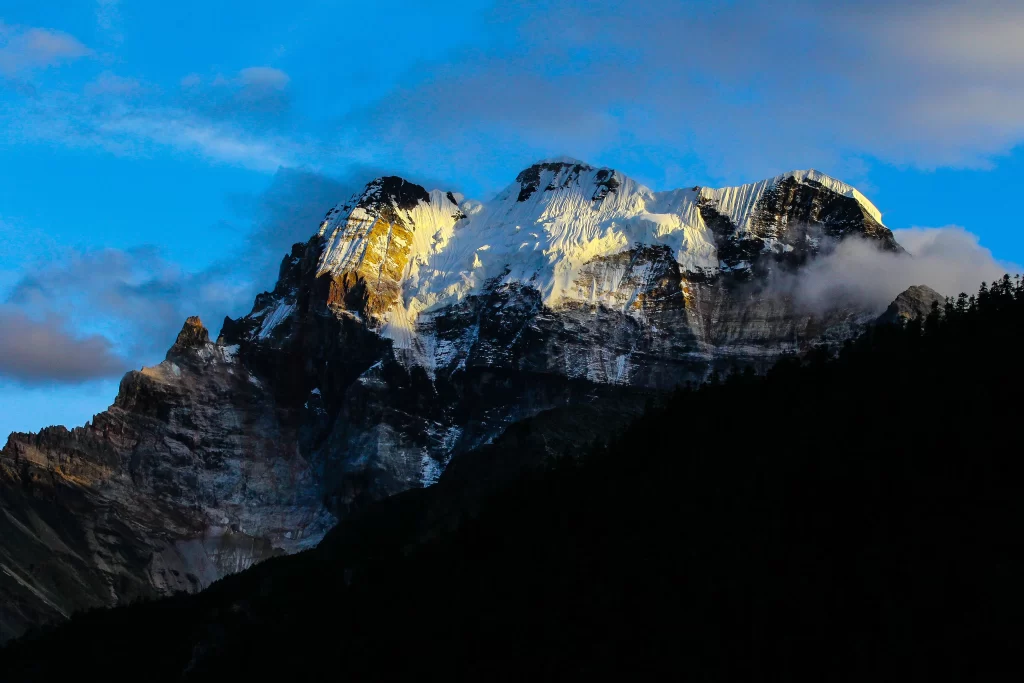 sunset golden amber snow peak ridge clouds blue