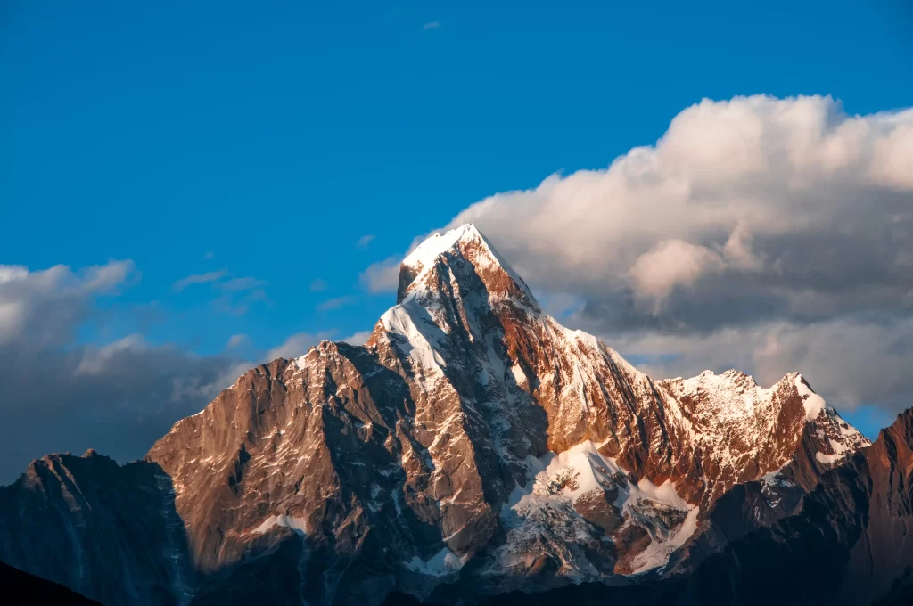 sunset golden amber snow peak ridge clouds cyan