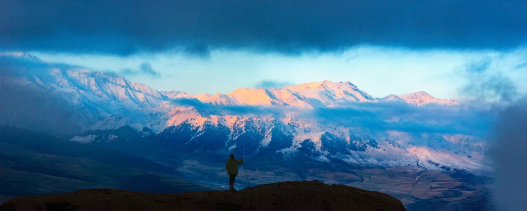 sunset golden amber snow peak ridge valley clouds orange