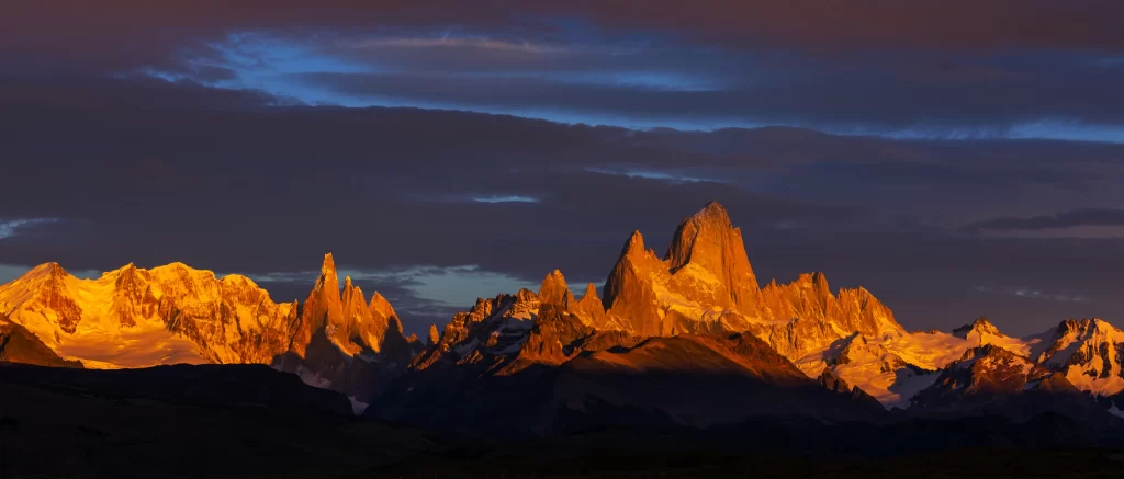 sunset golden amber snow peak ridge clouds panoramic purple