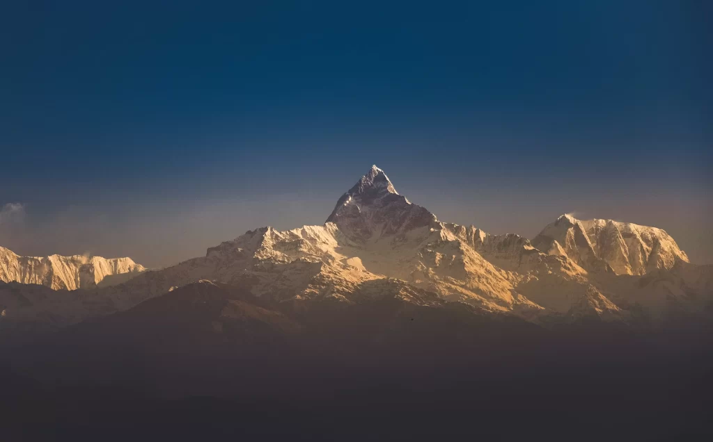 sunset golden amber snow peak ridge wide panoramic blue