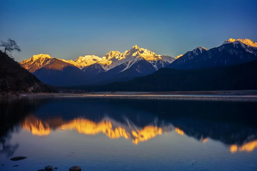 sunset golden blue orange snow-capped reflection tranquil mountain range