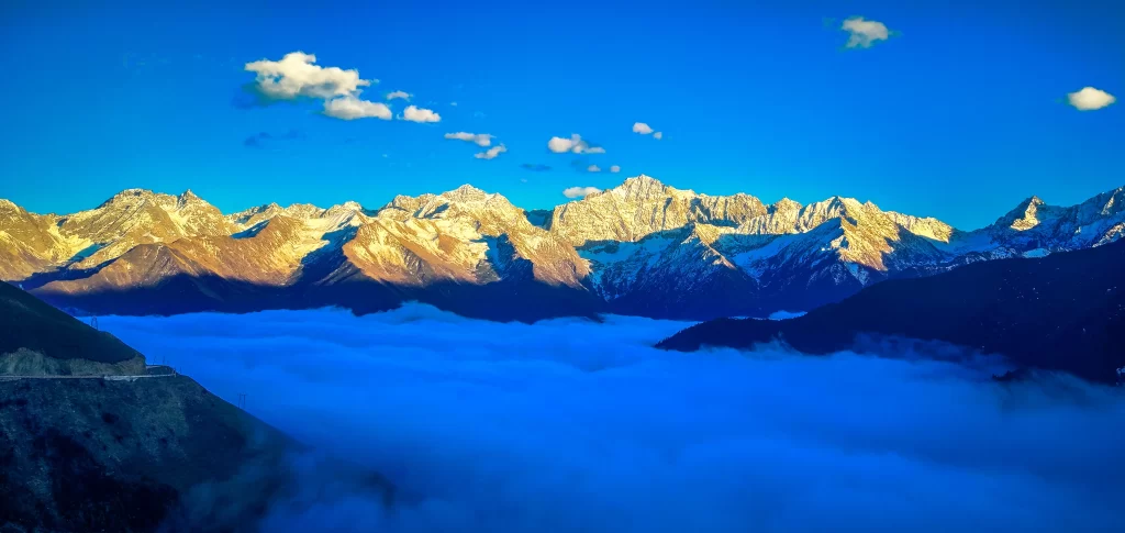 sunset golden blue white clouds snow peaks mist tranquil