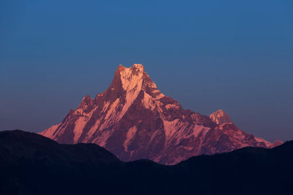 sunset golden orange blue snow-capped mountain silhouette tranquil