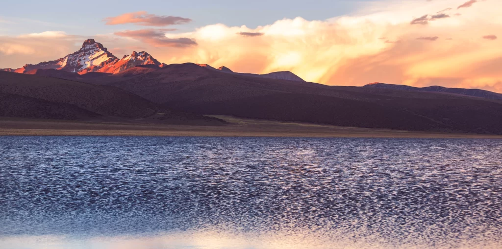 sunset golden orange pink blue snow peak lake reflection ridge