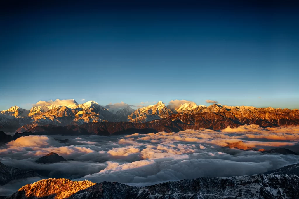 sunset golden orange snow peak ridge valley clouds aerial