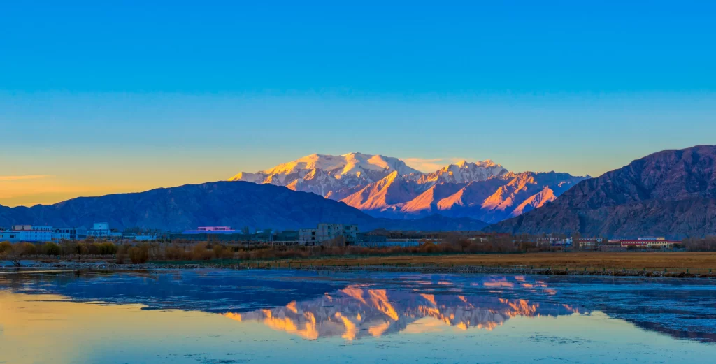 sunset golden orange snow peak ridge lake reflection valley grassland
