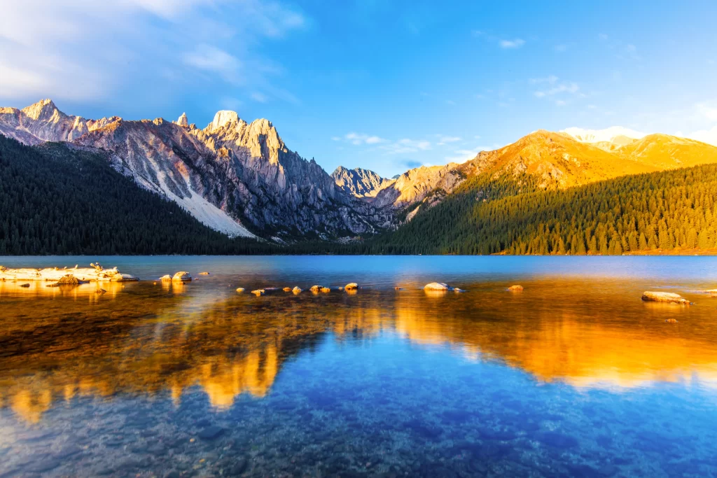 sunset golden orange teal blue ridge lake reflection valley clouds