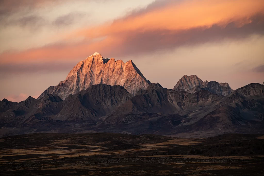 sunset golden rugged peaks dramatic sky serene vast natural tranquil