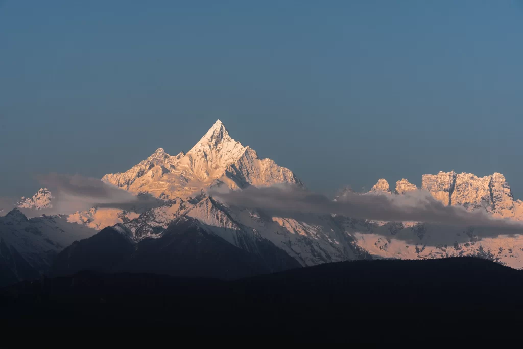 sunset golden snow-capped peaks clear sky mountain range cloud rugged