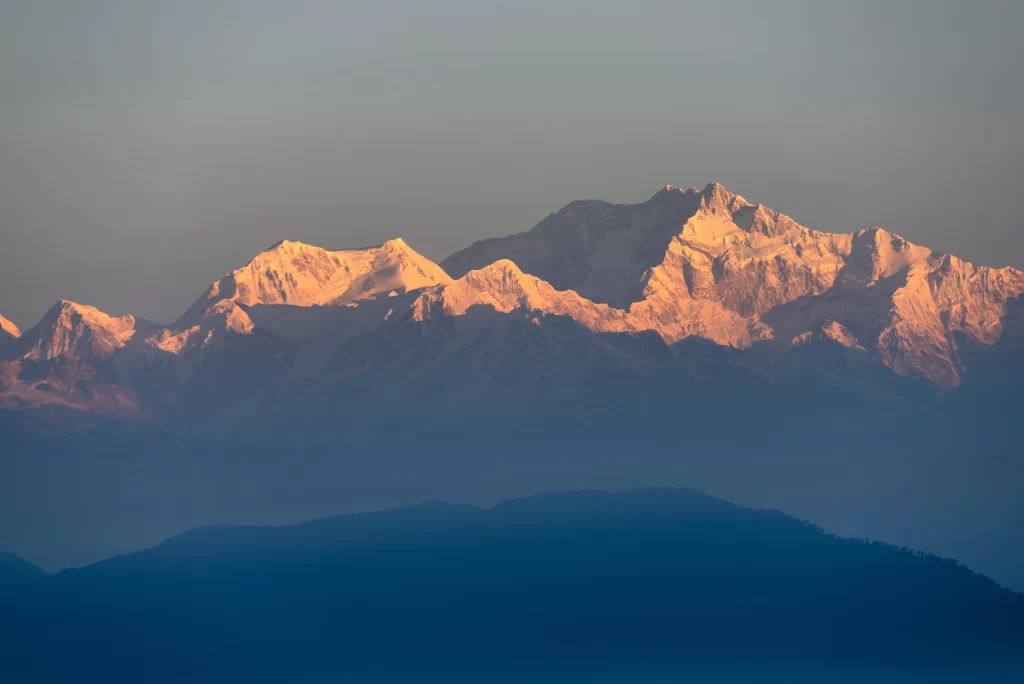 sunset golden snow peak ridge teal blue valley gray