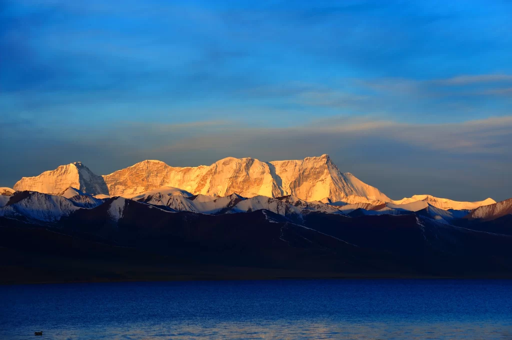 sunset golden snow peak ridge lake reflection blue purple aerial