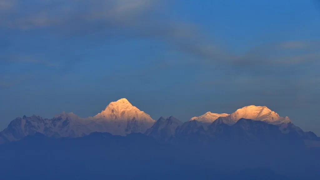 sunset snow-capped peaks golden deep blue sky mountain range tranquil