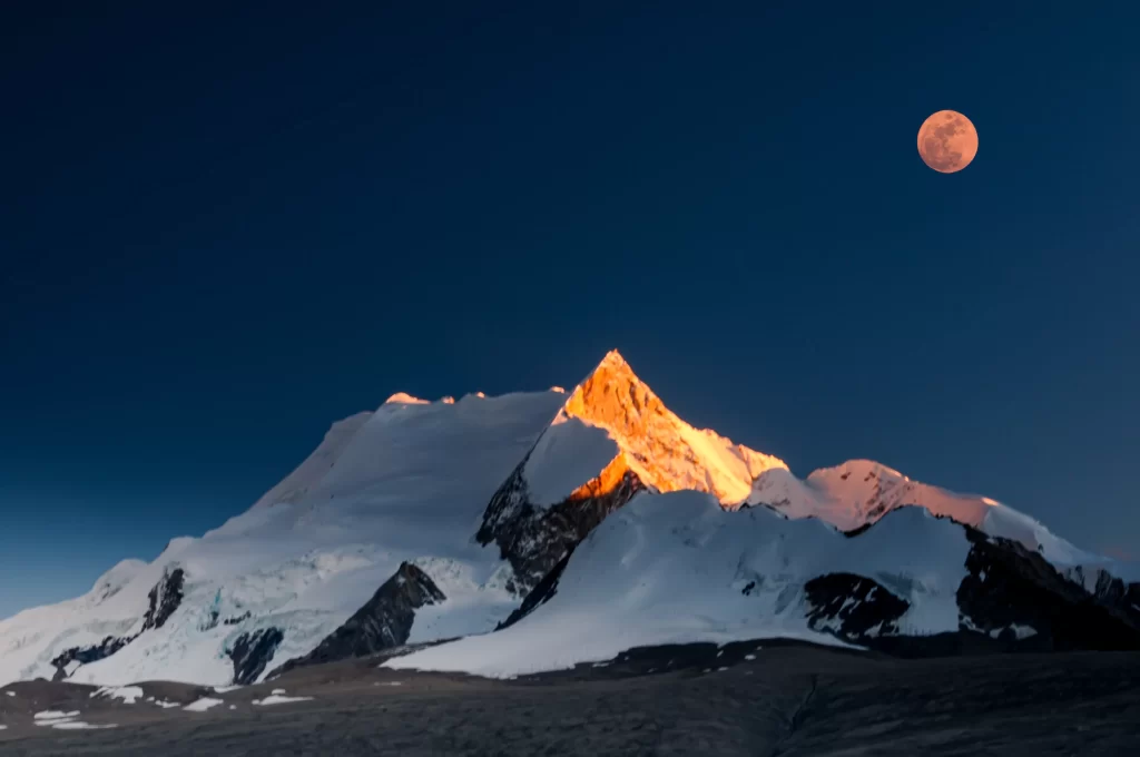 sunset twilight golden orange blue snow-capped mountain moon