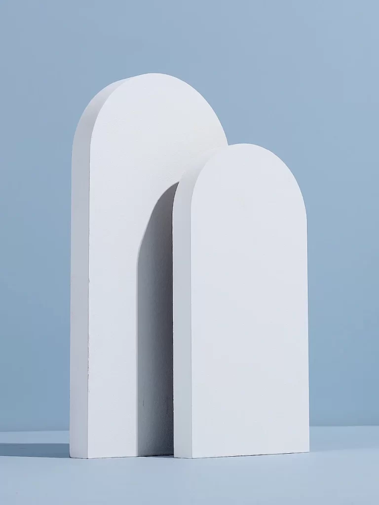 White Arched Sculptures Against Blue Background