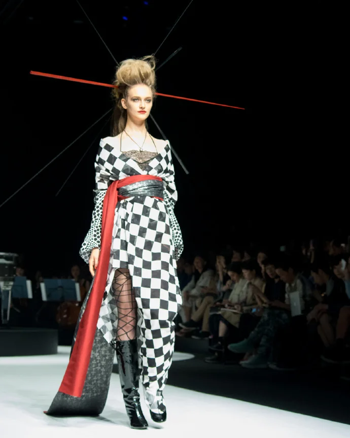Fashion show avant-garde checkered pattern red sash black boots