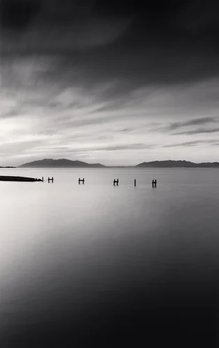 Minimalist Water Poles Silhouettes Dramatic Atmospheric Seascape