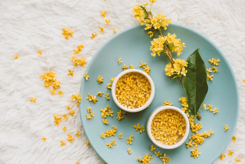 Yellow Osmanthus Petals Green Leaves Blue Plate